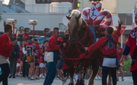 Handlers working to control a horse