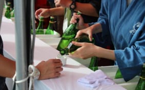 Servers pouring Japanese sake